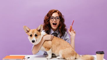 curly-girl-shirt-eyeglasses-hugs-dog-holds-pencil